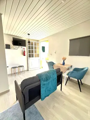 a living room with a couch and a tv at Home Thomas in Lombada dos Marinheiros