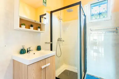 a bathroom with a sink and a shower at Home Thomas in Lombada dos Marinheiros