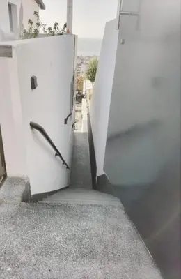 a white door with a handle on the side of a building at Vila Loki in Funchal