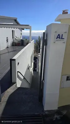 a building with an open door on the side at Vila Loki in Funchal