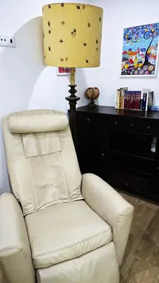 a white chair and a lamp in a room at Vila Loki in Funchal