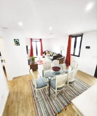 a living room with a glass table and chairs at Vila Loki in Funchal