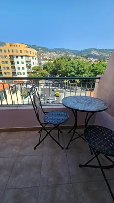 a table and two chairs sitting on a balcony at Garden and Seaview Apartment - Free Parking in Funchal