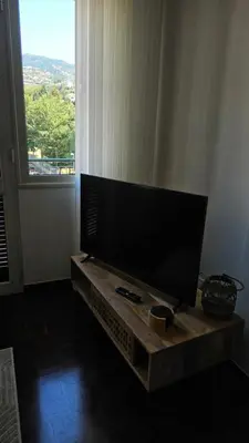 a flat screen tv sitting on a table in a living room at Garden and Seaview Apartment - Free Parking in Funchal