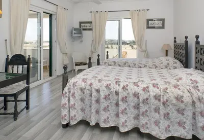 a bedroom with a bed with a red and white bedspread at LGS32V5 moradia grande conforto, lugar sossegado in Lagos