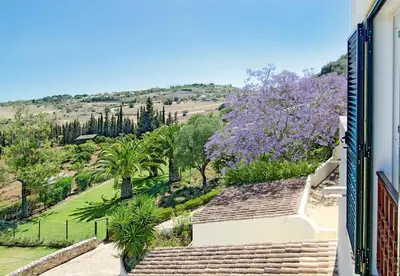 a view from the balcony of a house with purple trees at LGS32V3 moradia de grande conforto in Lagos