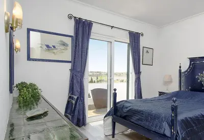 a bedroom with a bed and a large window at LGS32V3 moradia de grande conforto in Lagos