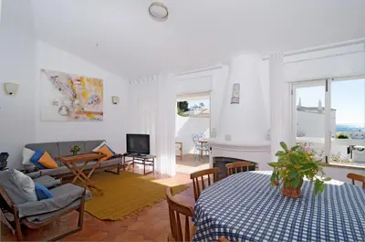 a living room with a couch and a table at LGS62 V3 casa e jardim a 100mts praia da Luz in Luz