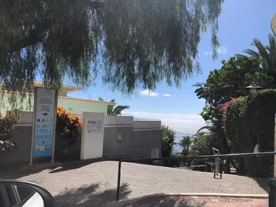 a view of a building with the ocean in the background at Beach Studio Apartment in Funchal
