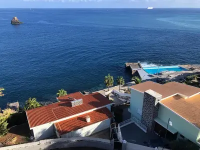 an aerial view of a house and the ocean at Beach Studio Apartment in Funchal