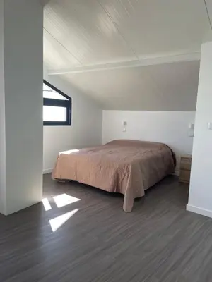 a bedroom with a bed in a white room at Neves GuestLoft by Madeira Holiday Rentals in Ribeira Brava