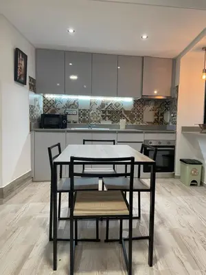 a kitchen with a table and chairs in a room at Neves GuestLoft by Madeira Holiday Rentals in Ribeira Brava