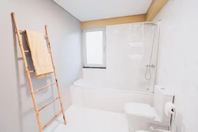 a bathroom with a shower and a toilet and a ladder at Elephant by Wanderlust Madeira - 2BR Apartment with Terrace, side Sea View and pool access in Funchal