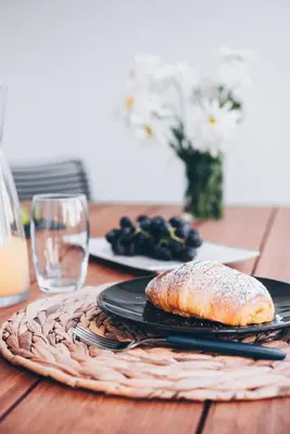 a table with two plates of food on a table at Elephant by Wanderlust Madeira - 2BR Apartment with Terrace, side Sea View and pool access in Funchal
