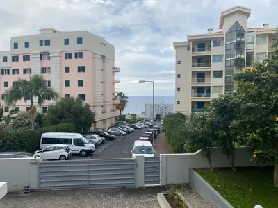 a street with cars parked in a parking lot at Elephant by Wanderlust Madeira - 2BR Apartment with Terrace, side Sea View and pool access in Funchal