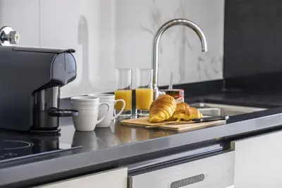 a kitchen counter with croissants and glasses of orange juice at Inner City by Homie in Funchal