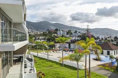 a view from the balcony of a house with palm trees at Inner City by Homie in Funchal