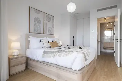 a white bedroom with a large bed with white sheets at Inner City by Homie in Funchal