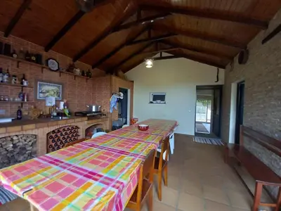 a dining room with a long table in a kitchen at Peaceful place in Porto Moniz in Salão