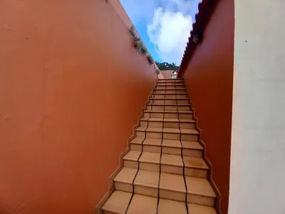 a stairway leading up to a building with the sky at Peaceful place in Porto Moniz in Salão