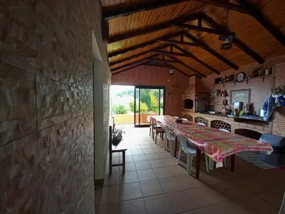 a kitchen with a long table in a room at Peaceful place in Porto Moniz in Salão