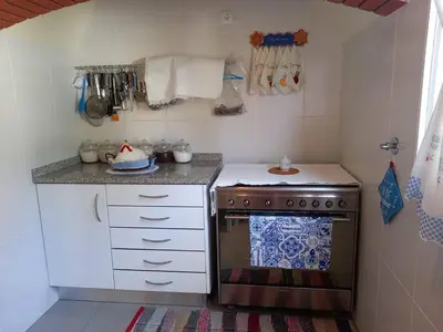 a kitchen with a stove and a counter top at Peaceful place in Porto Moniz in Salão