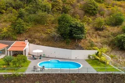 an overhead view of a swimming pool next to a house at Belo Mar in Arco da Calheta
