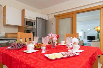 a dining room table with a red table cloth at Belo Mar in Arco da Calheta