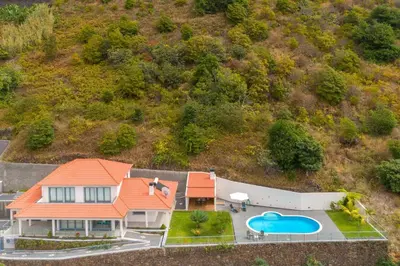an aerial view of a house with a swimming pool at Belo Mar in Arco da Calheta