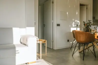a living room with a table and a chair at Villa Beatriz Ocean View in Aljezur