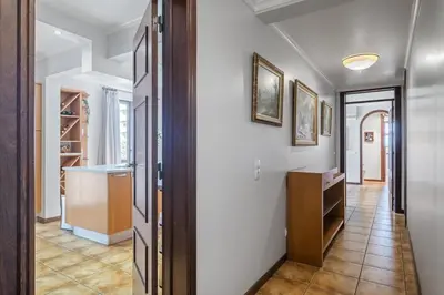 a hallway with white walls and a door to a room at Central Lido Apartment by Homie in Funchal