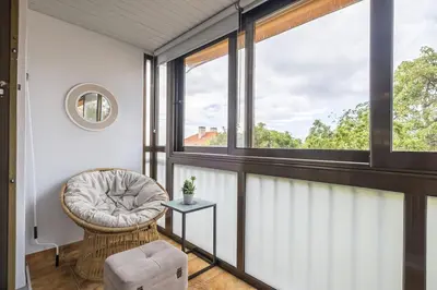 a room with a chair and a window at Central Lido Apartment by Homie in Funchal