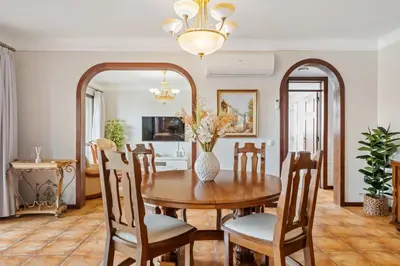 a dining room with a table and chairs and a mirror at Central Lido Apartment by Homie in Funchal