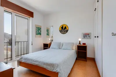 a bedroom with a bed and a large window at Casa da Irene - A047 in Luz