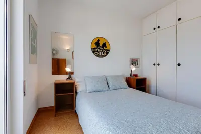a bedroom with a blue bed and white cabinets at Casa da Irene - A047 in Luz