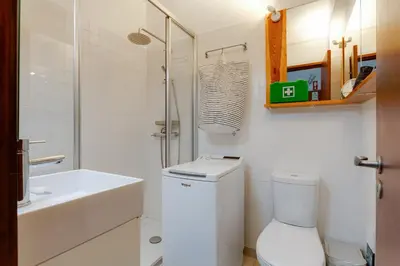 a white bathroom with a toilet and a sink at Casa da Irene - A047 in Luz