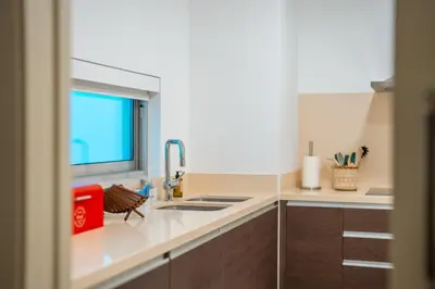 a kitchen with a sink and a window at Sea View - 3 Pools - Parking - Gym - Supermarket - Prime Location in Funchal