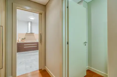 a bathroom with a glass door leading into a kitchen at Sea View - 3 Pools - Parking - Gym - Supermarket - Prime Location in Funchal