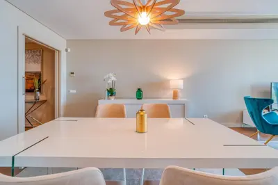 a dining room with a white table and chairs at Sea View - 3 Pools - Parking - Gym - Supermarket - Prime Location in Funchal