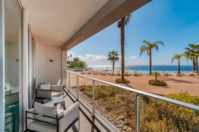 a balcony with chairs and a view of the ocean at Sea View - 3 Pools - Parking - Gym - Supermarket - Prime Location in Funchal