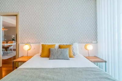 a bedroom with a bed with yellow pillows and two lamps at Sea View - 3 Pools - Parking - Gym - Supermarket - Prime Location in Funchal