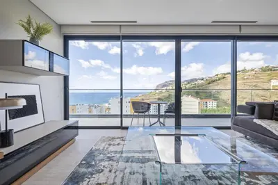 a living room with a view of the ocean at Tower Penthouse by Homie in Funchal