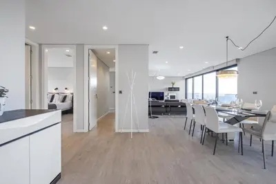 a kitchen and dining room with a table and chairs at Tower Penthouse by Homie in Funchal