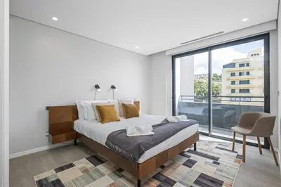 a bedroom with a bed and a large window at Tower Penthouse by Homie in Funchal