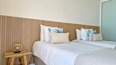 two beds sitting next to each other in a room at Ohana Ocean View by Lovelystay in Arco da Calheta