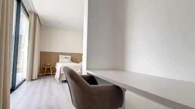 a room with a bed and a table and chairs at Ohana Ocean View by Lovelystay in Arco da Calheta