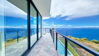 a view of the ocean from the balcony of a house at Ohana Ocean View by Lovelystay in Arco da Calheta
