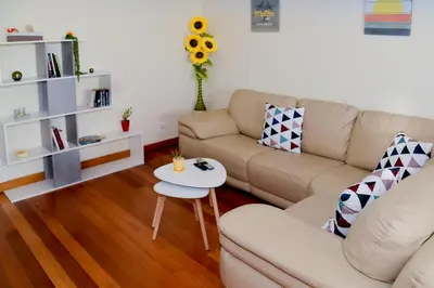 a living room with a couch and a table at Green Pearl Apartment in Funchal