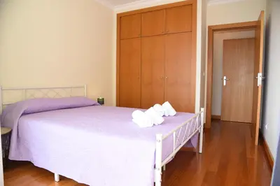 a bedroom with a bed with two towels on it at Green Pearl Apartment in Funchal