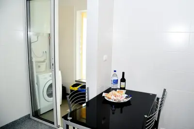a table with a bottle of wine and a plate of food at Green Pearl Apartment in Funchal